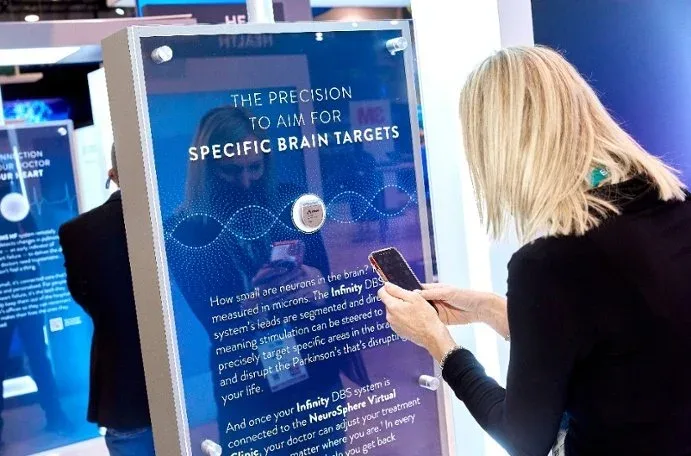 Visitor reading the brain targets kiosk