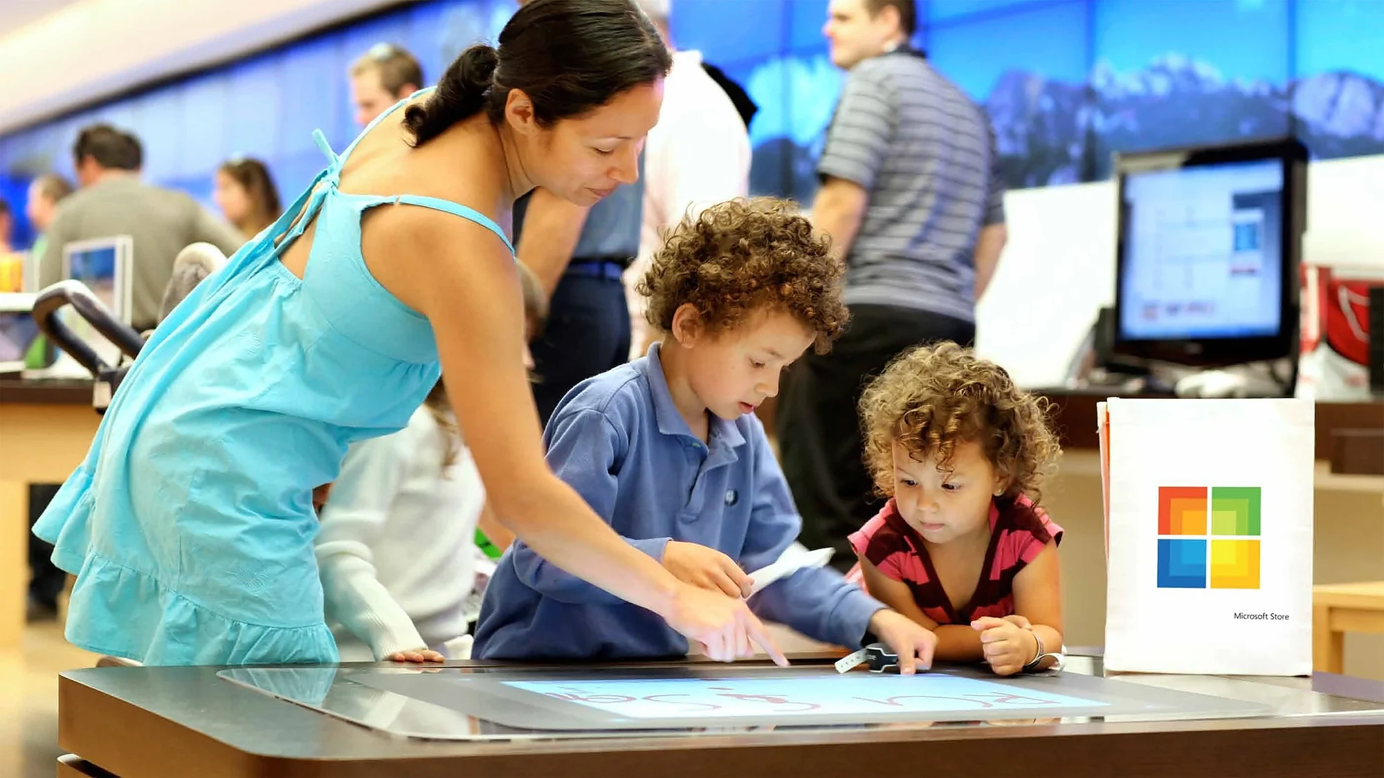 Family at a Microsoft Store touch table